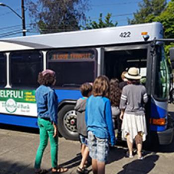 Picture of youth and teacher boarding a bus