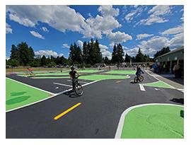 children riding bikes in a traffic garden